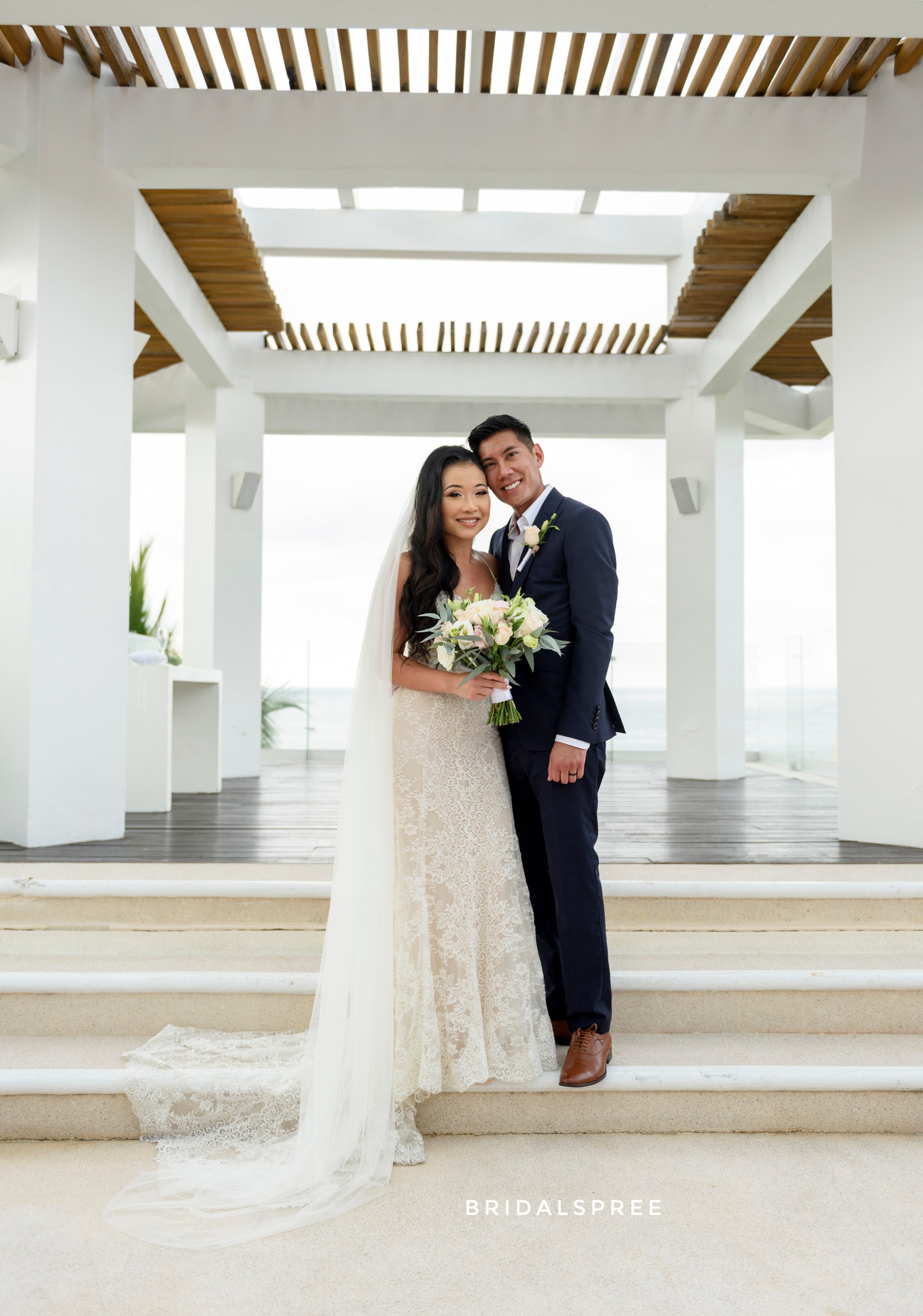 bride wearing chapel length veil for outdoor destination wedding