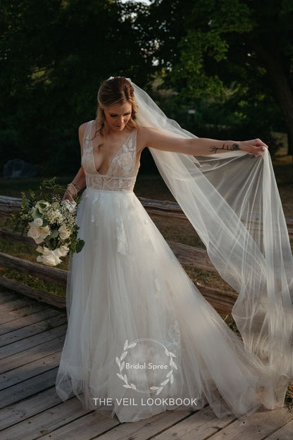 Bride wearing soft simple long cathedral veil with A line tulle dress for rustic wedding 